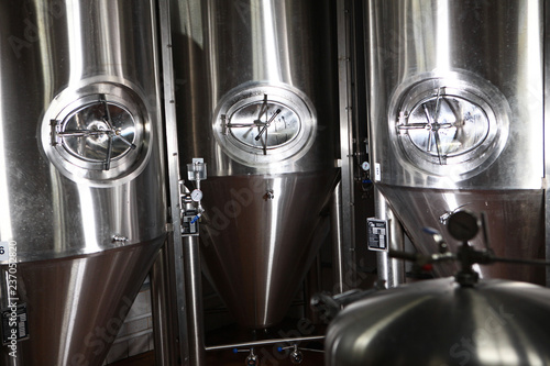 Large tanks for fermentation of beer at the brewery. Equipment for the brewery. The concept of the industry in the processing of malt.