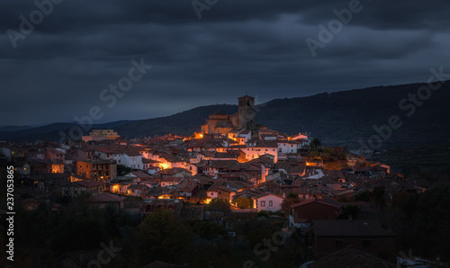 View of small town at cloudy night photo