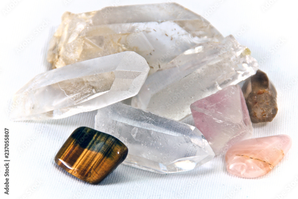 Close up of quartz crystals and tiger's eye stone on white. Not isolated Close up of quartz crystals and tiger's eye stone on white. Not isolated