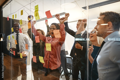 Cheering businesspeople celebrating after an office brainstormin photo