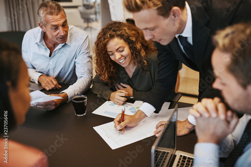 Diverse businesspeople going over documents together in an offic photo