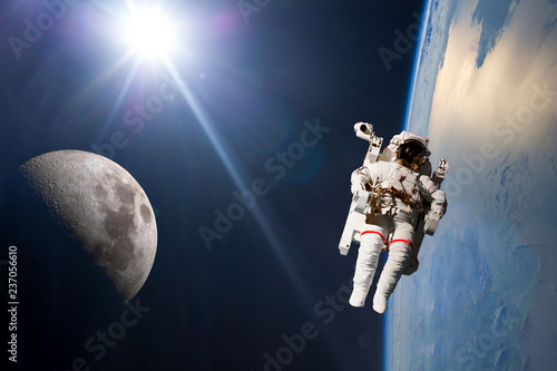 Fototapeta Naklejka Na Ścianę i Meble -  planet earth and moon orbit with ship and stronaut. Elements of this image furnished by NASA f