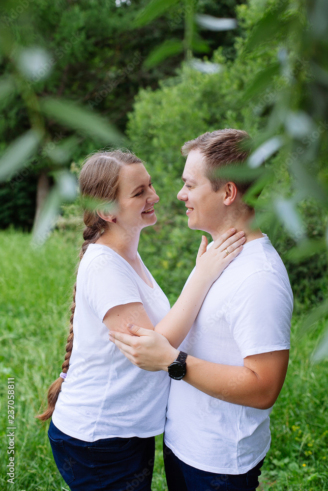 Happy pregnant woman and her husband in the park Happy pregnant woman and her husband in the park