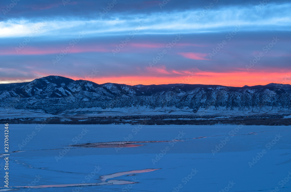 Sunset Winter Mountain Lake - Colorful sunset at a frozen mountain lake. Chatfield Reservoir in Chatfield State Park, southwest of Denver-Littleton, Colorado, USA.
