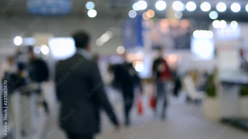Abstract Defocused Blurred Background flow of many people inside space shopping center or mall, exhibition, exposition, hall real time. Abstract Defocused Blurred Background flow of many people inside space shopping center or mall, exhibition, exposition, hall real time.