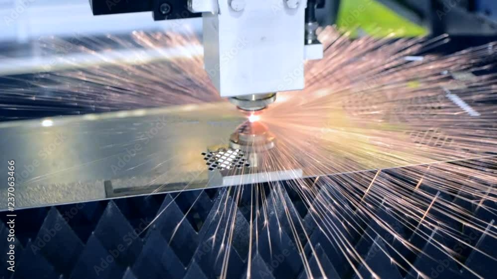 Fiber laser machines for metal cutting close-up. A laser beam cuts the sheet metal in the manufacture. Industrial technologies, production processes