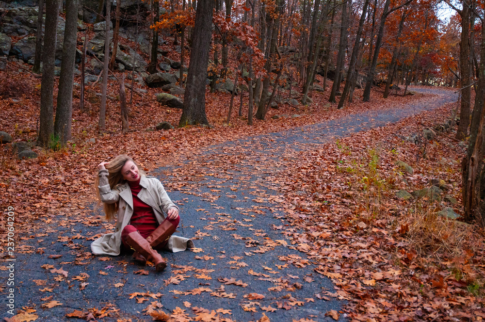 Fototapeta premium Beautiful woman in coat in the autumn forest.