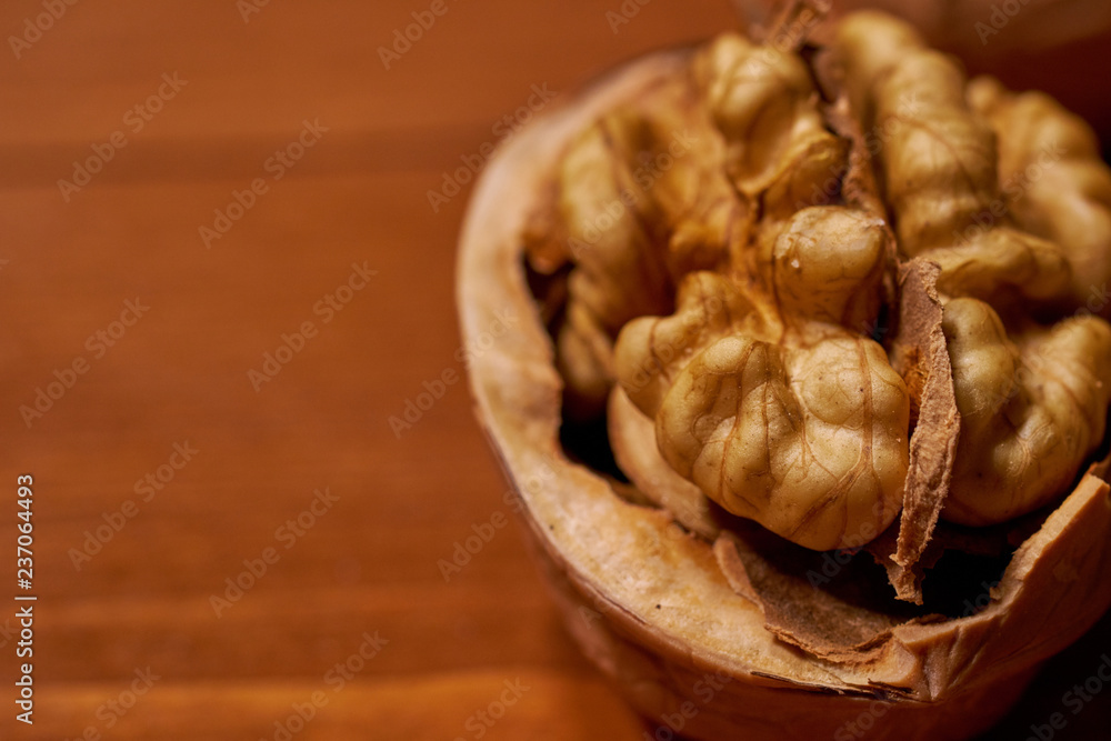 Walnut on brown wooden background. Selective focus Walnut on brown wooden background. Selective focus