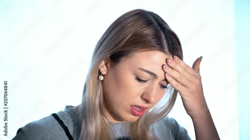 A girl’s headache, a woman has headache in different life circumstances, she clearly shows that she is in pain, clutches her head, a woman’s migraine, takes migraine pills, works on camera A girl’s headache, a woman has headache in different life circumstances, she clearly shows that she is in pain, clutches her head, a woman’s migraine, takes migraine pills, works on camera