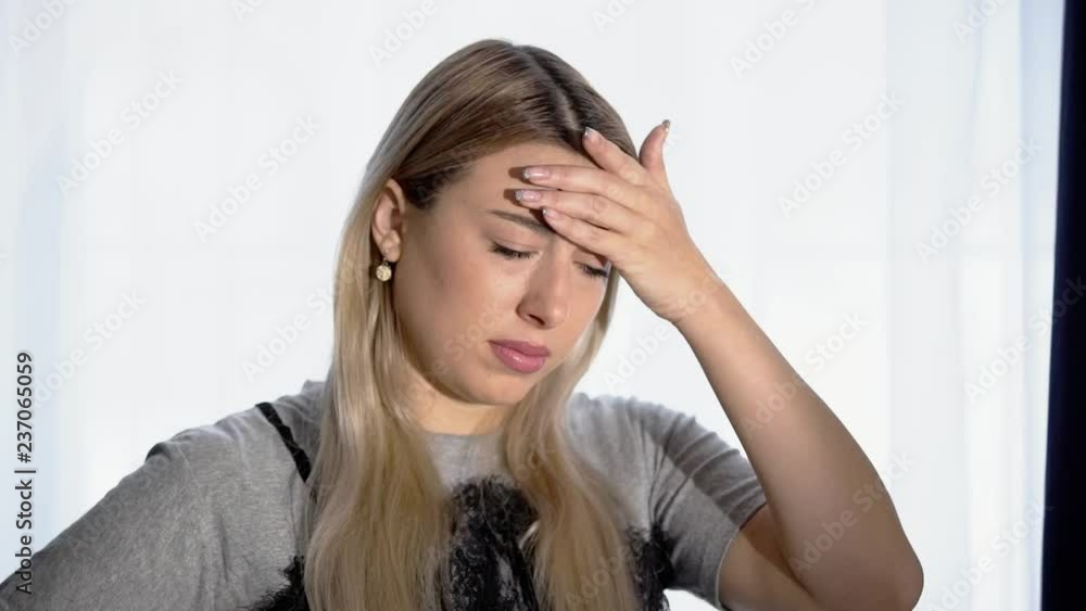 A girl’s headache, a woman has headache in different life circumstances, she clearly shows that she is in pain, clutches her head, a woman’s migraine, takes migraine pills, works on camera A girl’s headache, a woman has headache in different life circumstances, she clearly shows that she is in pain, clutches her head, a woman’s migraine, takes migraine pills, works on camera