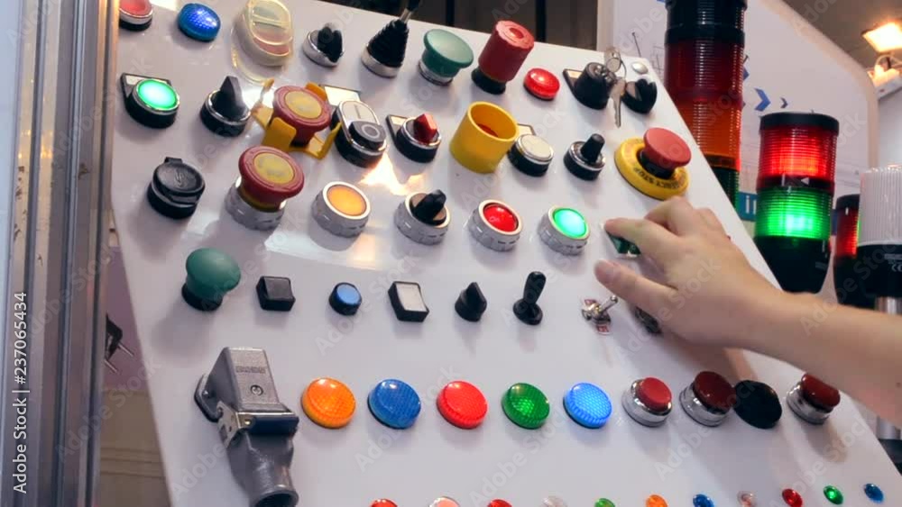 Person clicks pushing on the control panel buttons and pressing the lever close-up. Person tilts the lever to turn it on oa turn off. Control buttons panel close-up. Person clicks pushing on the control panel buttons and pressing the lever close-up. Person tilts the lever to turn it on oa turn off. Control buttons panel close-up.