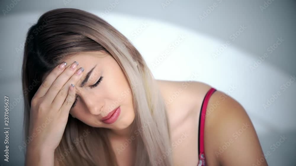 A girl’s headache, a woman has headache in different life circumstances, she clearly shows that she is in pain, clutches her head, a woman’s migraine, takes migraine pills, works on camera A girl’s headache, a woman has headache in different life circumstances, she clearly shows that she is in pain, clutches her head, a woman’s migraine, takes migraine pills, works on camera