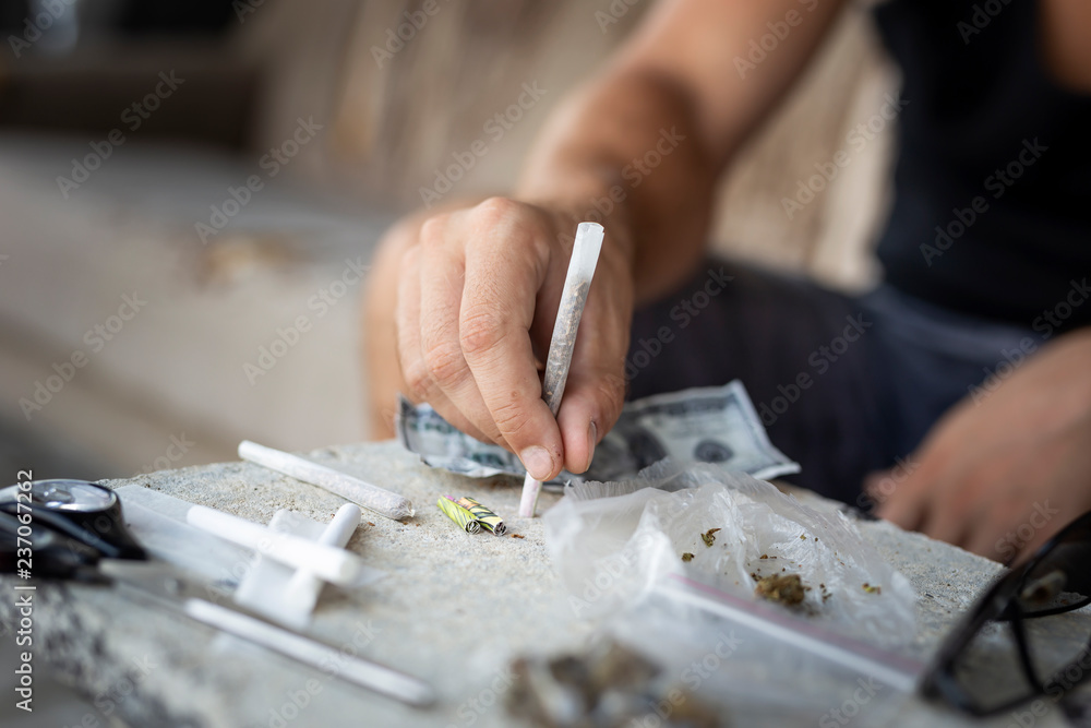 Fototapeta premium Man rolling a joint