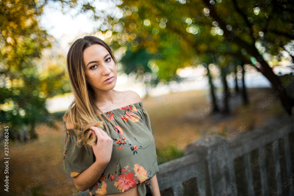 Photographing a girl during autumn with a blurred background Photographing a girl during autumn with a blurred background