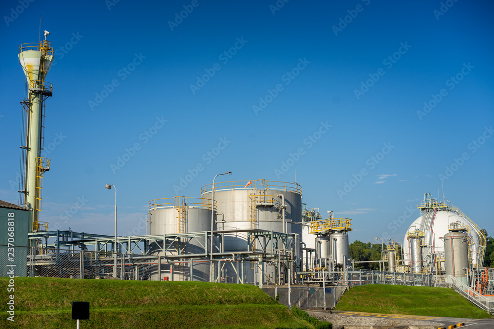 Close up Industrial view at oil refinery plant and silos form industry zone with blue sky Close up Industrial view at oil refinery plant and silos form industry zone with blue sky