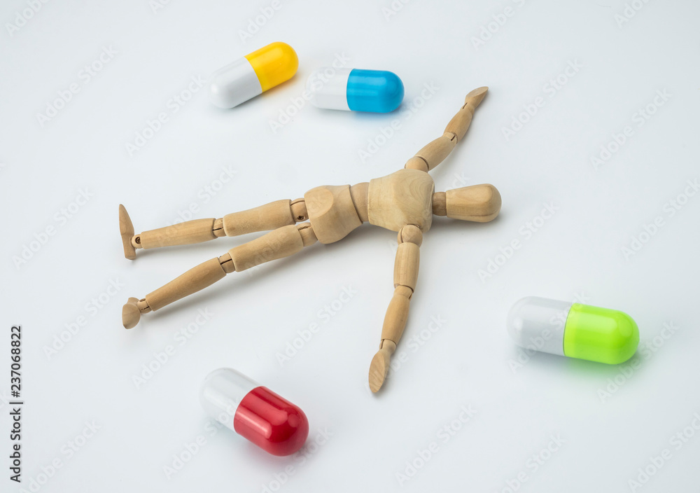 Doll articulated died of an overdose of pills, conceptual image Doll articulated died of an overdose of pills, conceptual image