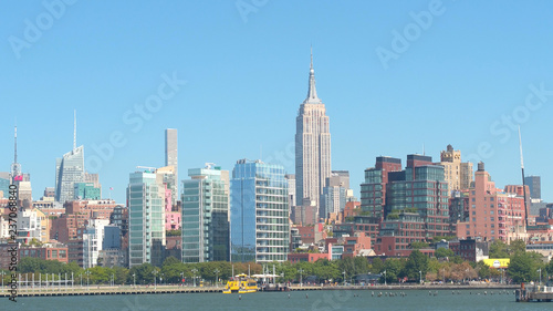 Ferry sightseeing cruise on Hudson River overlooking Midtown Manhattan skyline