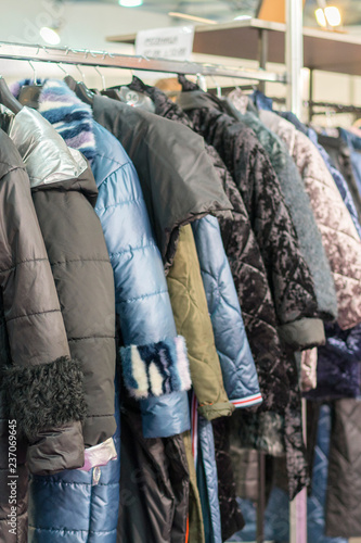 Winter Jacket in Winter Sale on a clothes rack. Women's coats on hangers in a women's clothing store. vertical photo.