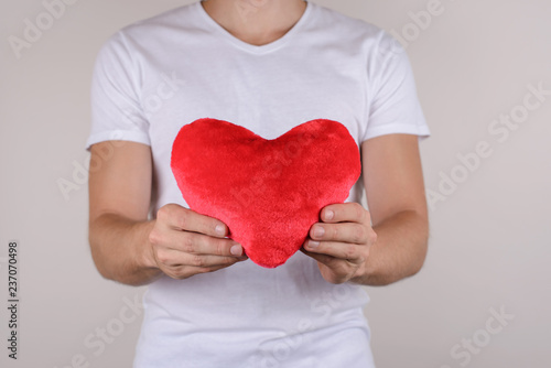 Fototapeta Naklejka Na Ścianę i Meble -  Passion life health healthy support help relief couple concept. Cropped close up photo studio portrait of handsome gentle macho gentleman holding big heart isolated grey background