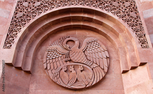 A bird feeding its chicks its blood - old symbol of self-sacrifice on the wall of Armenian Orthodox church (Moscow, Russia) photo