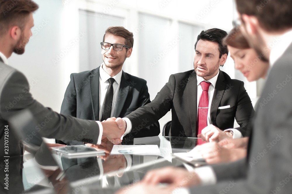 handshake business partners at the Desk. handshake business partners at the Desk.