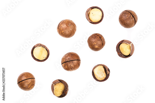 Shelled and unshelled macadamia nuts isolated on white background with copy space for your text. Top view. Flat lay pattern