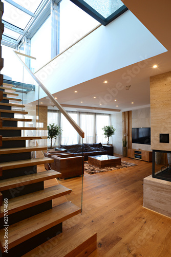 Transparent glazed ramp on ladder staircases in duplex with skylight