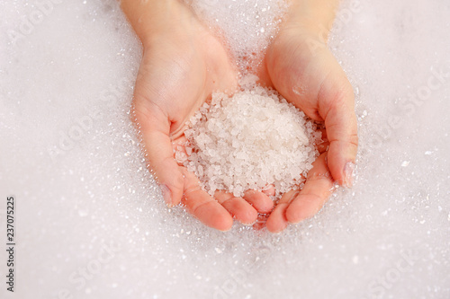Hands with bath salt, skincare spa concept
