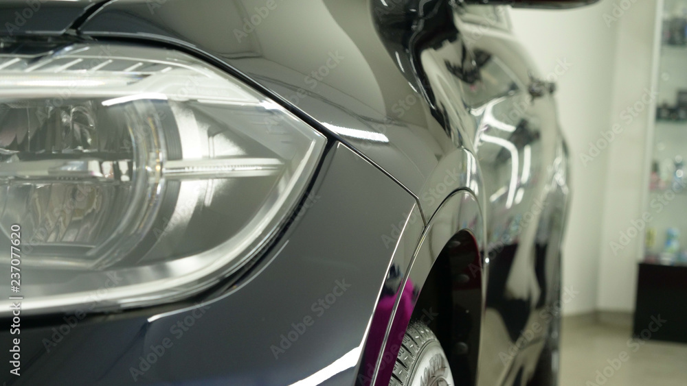 After professional polishing, ceramics and car washes show headlights on new cars. Concept of: Auto Service, Different Colors, Car wash, Presentation, Glittering Headlights.