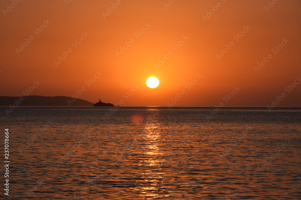 Golden hour Sundown, with view to Korfu island. Sunset on the beach in Ksamil near Saranda, Albania.