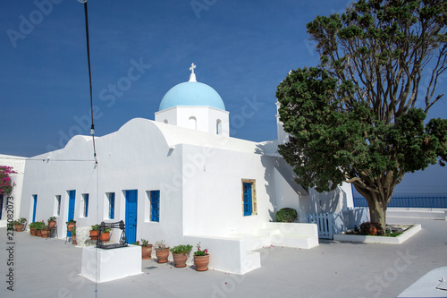 Traditional Orthodox blue dome church in Greece on a sunny summer day, with the typical blue and white colours. Santorini, Cyclades Islands, Greece, Europe