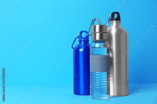 Different sport bottles with space for text on color background