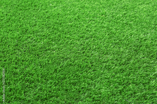 Artificial grass carpet as background, closeup. Exterior element