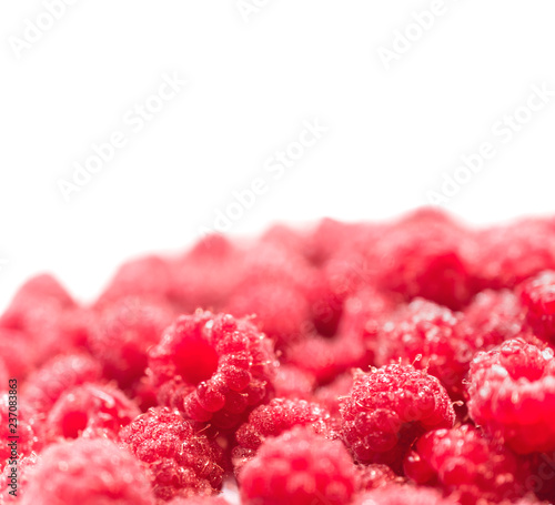 Dripping raspberry on white background.