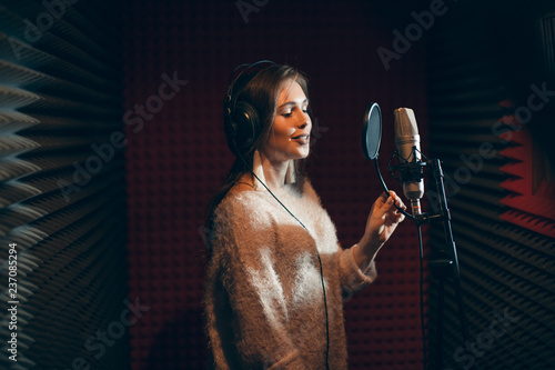 taleented young woman preparing for a concert. girl demonstrates her vocal skills . close up side view photo photo