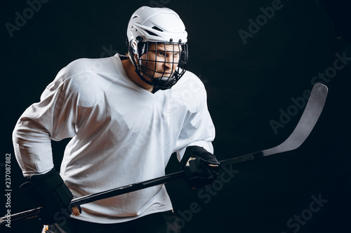 Photography Isolated shot of ice-hockey player in white sportswear and white helmet holding