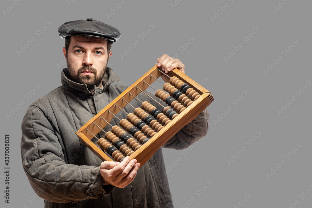 Old fashioned bearded man with retro abacus, studio shot. Isolated on gray background, with clipping path Old fashioned bearded man with retro abacus, studio shot. Isolated on gray background, with clipping path