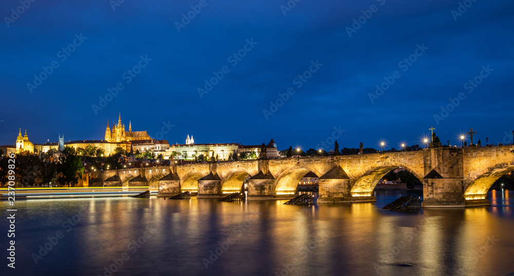 Prague, Czech Republic. Charles Bridge and Hradcany (Prague Castle) with St. Vitus Cathedral and St. George church evening dusk, Bohemia landmark in Praha.