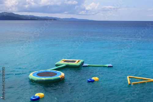 Inflatable trampolines and other inflatable water recreation equipment floating in the bay, Montego Bay, Jamaica.