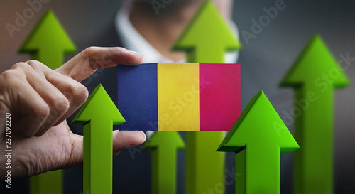 Nation Growth Concept, Green Up Arrows - Businessman Holding Card of Chad Flag