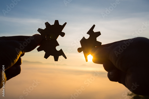 Silhouette Woman hands connecting couple puzzle piece against sunrise, Business solutions, target, success, goals and strategy concepts