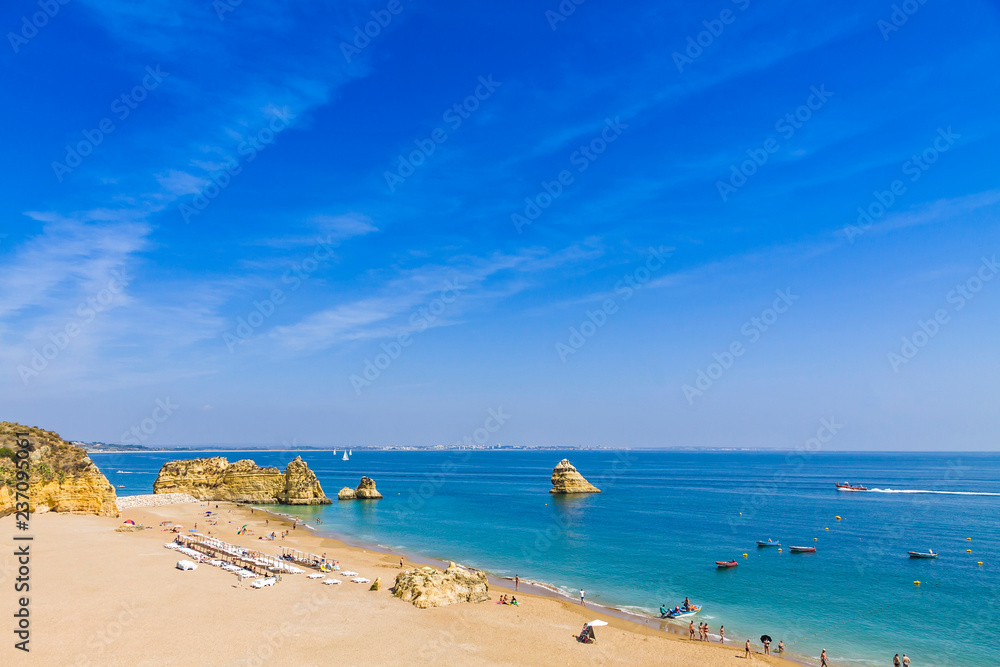 Picturesque view of Praia do Camilo beach in Lagos, Algarve region, Portugal. Praia do Camilo is one of the best beaches in Lagos. Famous for the crystal clear water and impressive cliff formations Picturesque view of Praia do Camilo beach in Lagos, Algarve region, Portugal. Praia do Camilo is one of the best beaches in Lagos. Famous for the crystal clear water and impressive cliff formations