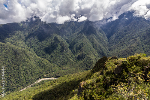 Views over the mountains and rainforest around Machu Picchu Citadel an amazing an idyllic scenery to view during a foggy morning. An amazing green landscape to enjoy with our eyes. Inca Trail, Peru