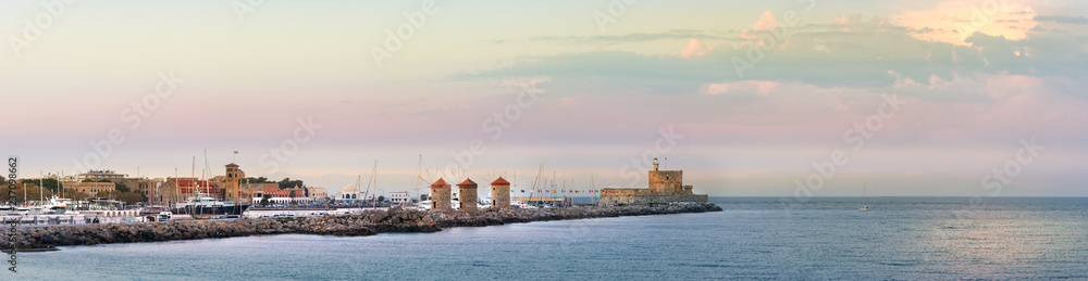 Panoramic view of the Windmills and the lighthouse at Mandraki Harbour, Rhodes, Greece.