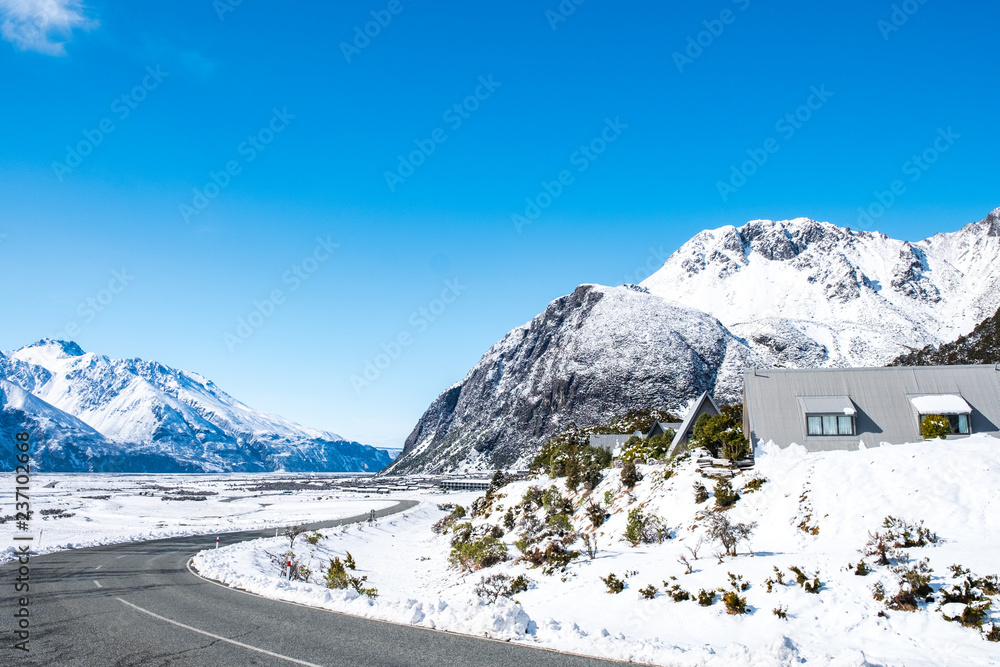View of a road in Mount Cook Village covered with white fresh snow after a snowy day. View of a road in Mount Cook Village covered with white fresh snow after a snowy day.