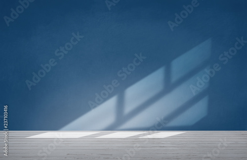Blue wall in an empty room with concrete floor