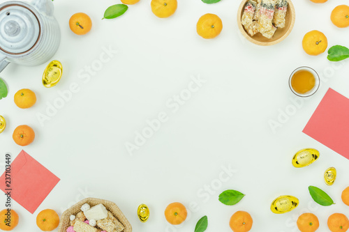Top view aerial image shot of arrangement decoration Chinese new year & lunar new year holiday background concept.Flat lay fresh orange with food & drink on modern white wooden at home office desk.
