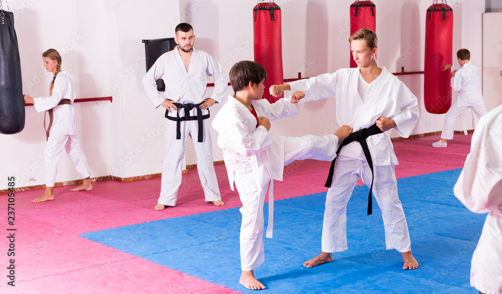 Children practicing karate in pair