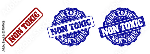NON TOXIC grunge stamp seals in red and blue colors. Vector NON TOXIC signs with grunge texture. Graphic elements are rounded rectangles, rosettes, circles and text labels.