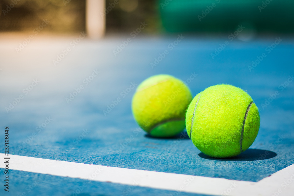 Tennis balls in court on corner blue floor